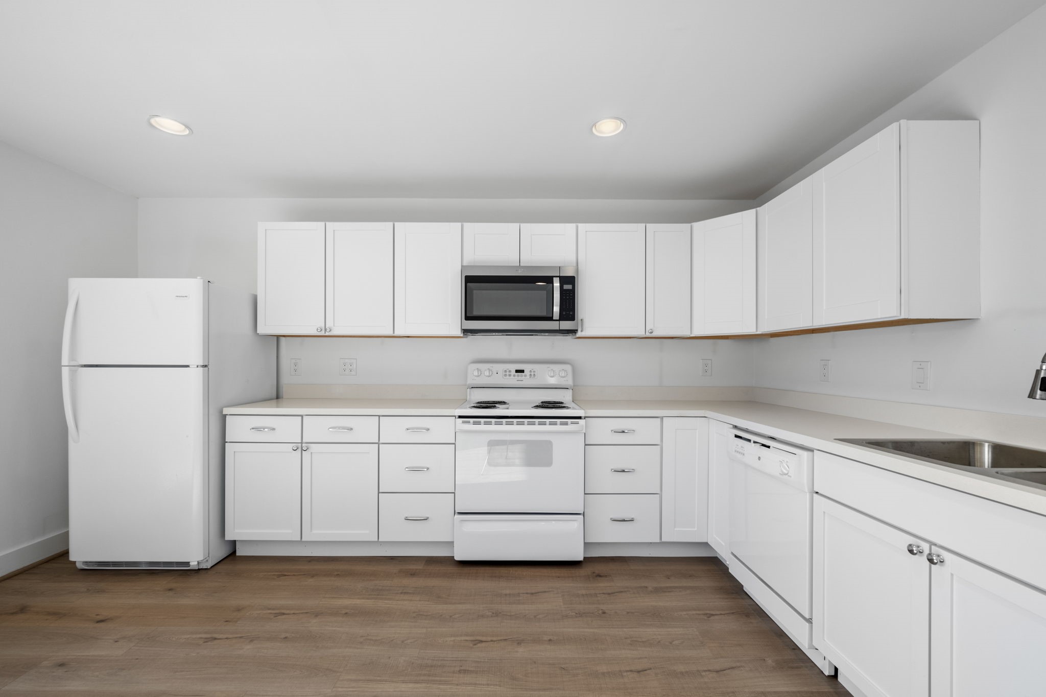 234 Westheimer Road, Unit 7 Houston, TX 77006 - Photo 10 of 18 a kitchen with stainless steel appliances granite countertop white cabinets and a refrigerator
