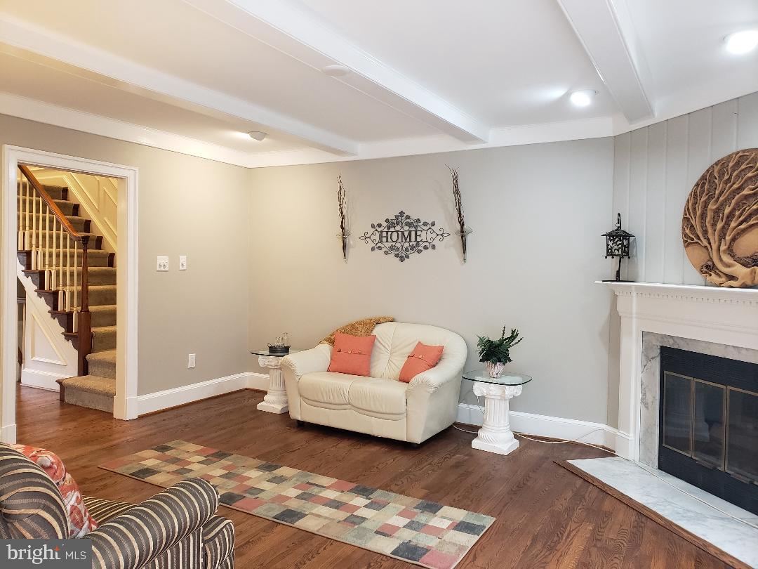 8049 Rising Ridge Road Bethesda, MD 20817 - Photo 11 of 33 a living room with furniture and a fireplace