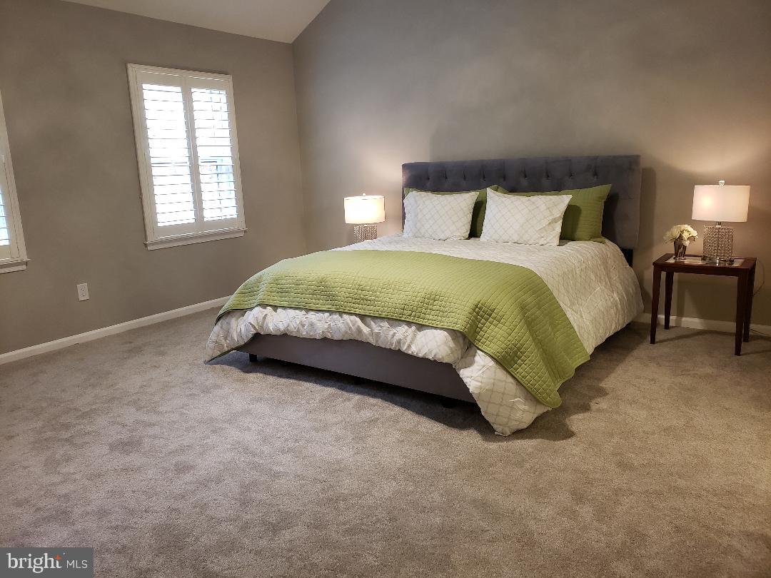 8049 Rising Ridge Road Bethesda, MD 20817 - Photo 14 of 33 a spacious bedroom with a bed and window
