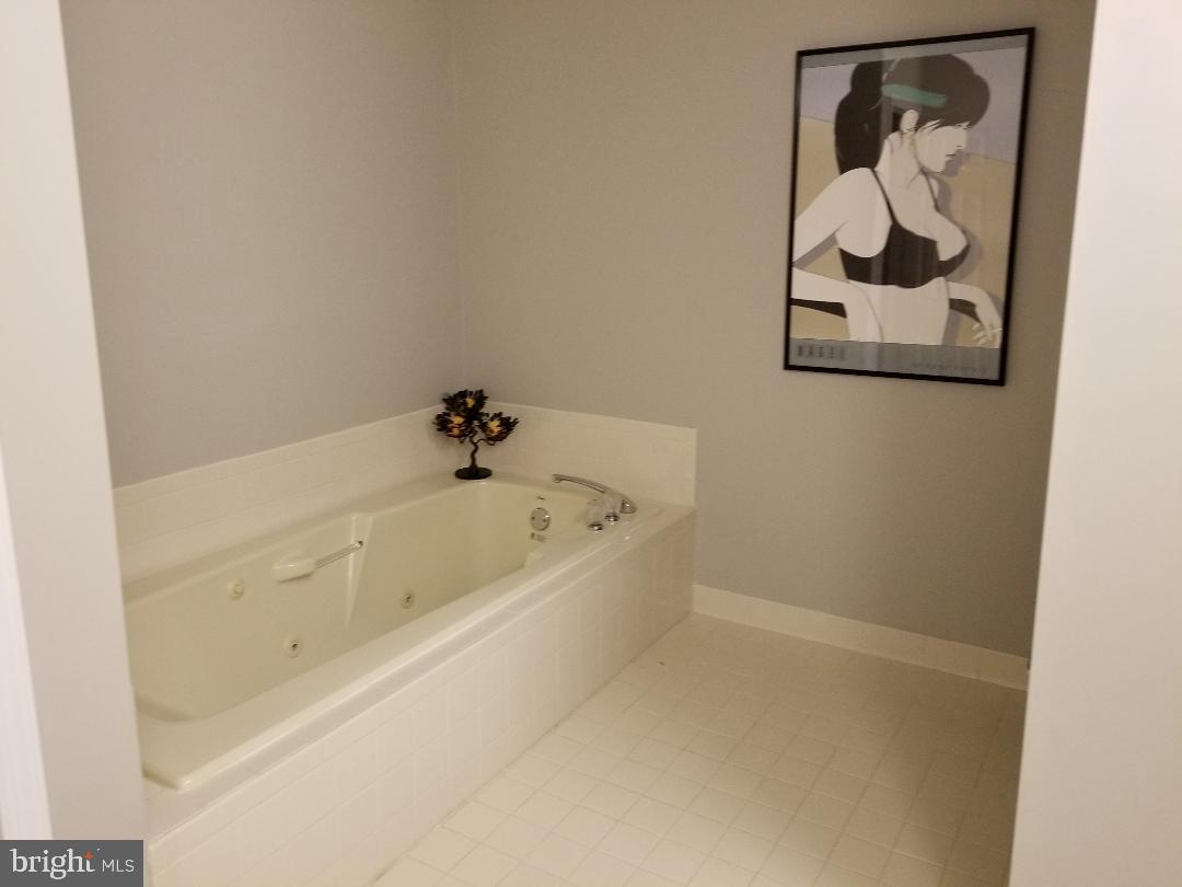 8049 Rising Ridge Road Bethesda, MD 20817 - Photo 23 of 33 a bathroom with a bathtub and a shower