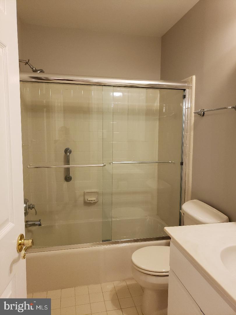 8049 Rising Ridge Road Bethesda, MD 20817 - Photo 28 of 33 a bathroom with a shower a toilet and sink