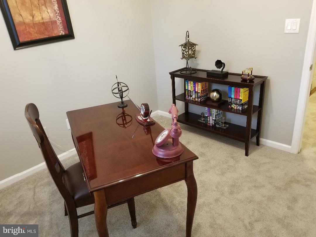 8049 Rising Ridge Road Bethesda, MD 20817 - Photo 30 of 33 a living room with furniture and a baby crib