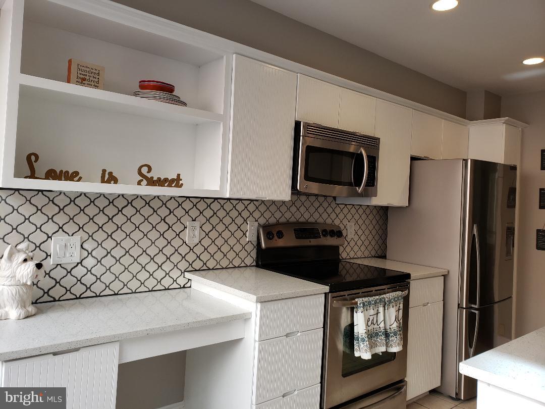8049 Rising Ridge Road Bethesda, MD 20817 - Photo 4 of 33 a kitchen with a refrigerator and a stove top oven