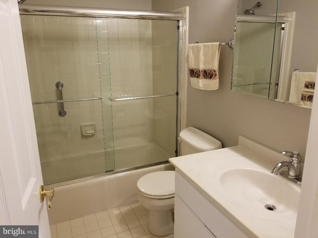 8049 Rising Ridge Road Bethesda, MD 20817 - Photo 31 of 33 a bathroom with a sink toilet and shower