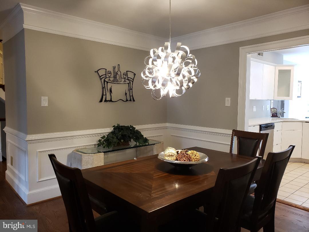 8049 Rising Ridge Road Bethesda, MD 20817 - Photo 6 of 33 a view of a dining room with furniture a chandelier and wooden floor