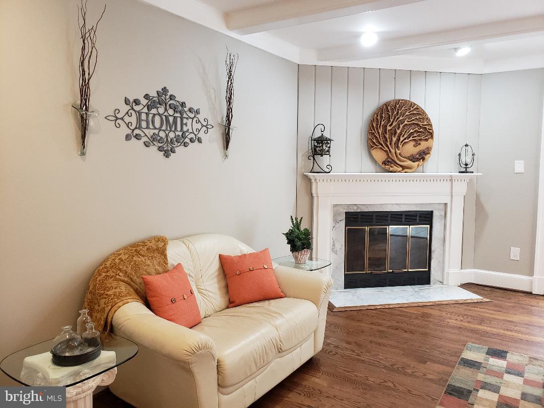 8049 Rising Ridge Road Bethesda, MD 20817 - Photo 10 of 33 a living room with furniture and a fireplace