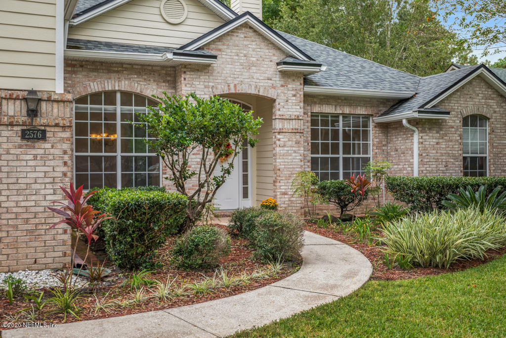 2576 Benjamin Road Jacksonville, FL 32223 - Photo 1 of 53 a front view of a house with garden