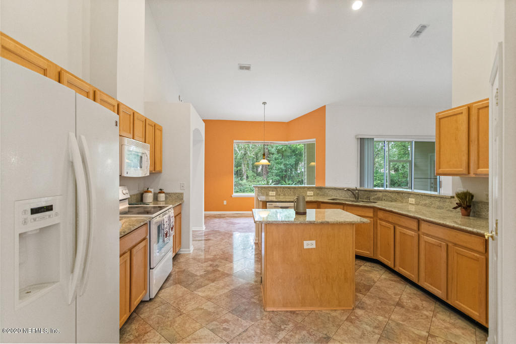 2576 Benjamin Road Jacksonville, FL 32223 - Photo 17 of 53 a large kitchen with stainless steel appliances granite countertop a sink and a refrigerator