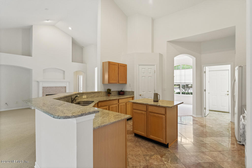 2576 Benjamin Road Jacksonville, FL 32223 - Photo 19 of 53 a kitchen with stainless steel appliances granite countertop a sink stove and cabinets