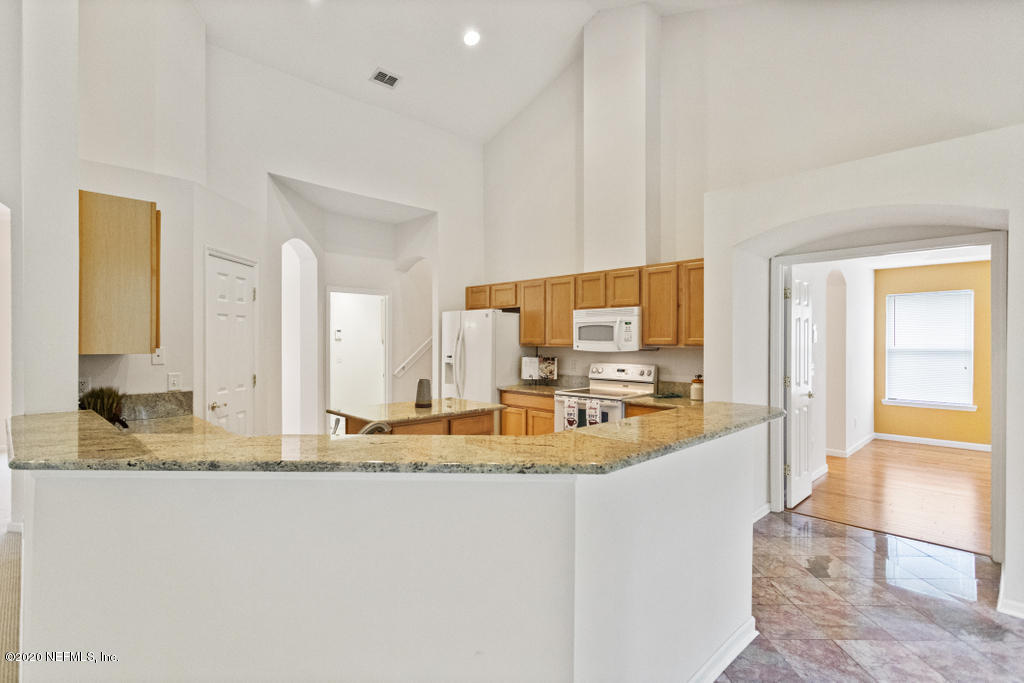 2576 Benjamin Road Jacksonville, FL 32223 - Photo 20 of 53 a view of a kitchen with kitchen island granite countertop a sink and cabinets