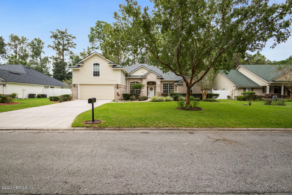 2576 Benjamin Road Jacksonville, FL 32223 - Photo 2 of 53 a front view of a house with a yard and garage