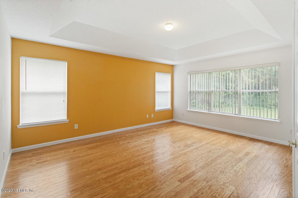 2576 Benjamin Road Jacksonville, FL 32223 - Photo 25 of 53 a view of an empty room with wooden floor and a window