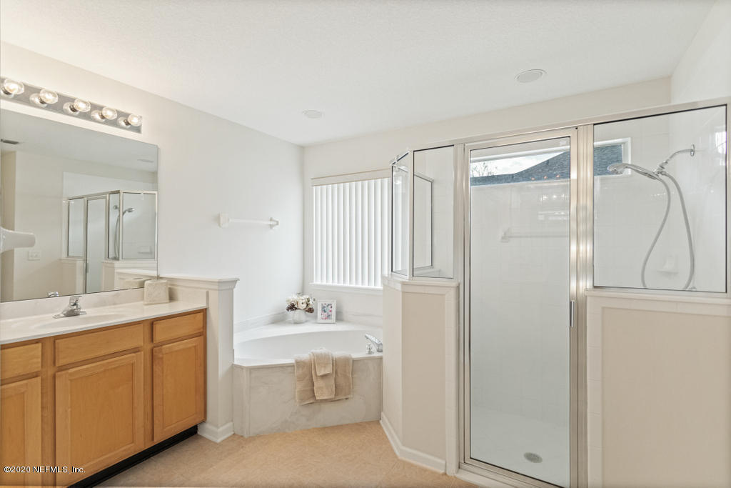 2576 Benjamin Road Jacksonville, FL 32223 - Photo 30 of 53 a bathroom with a double vanity sink mirror and shower