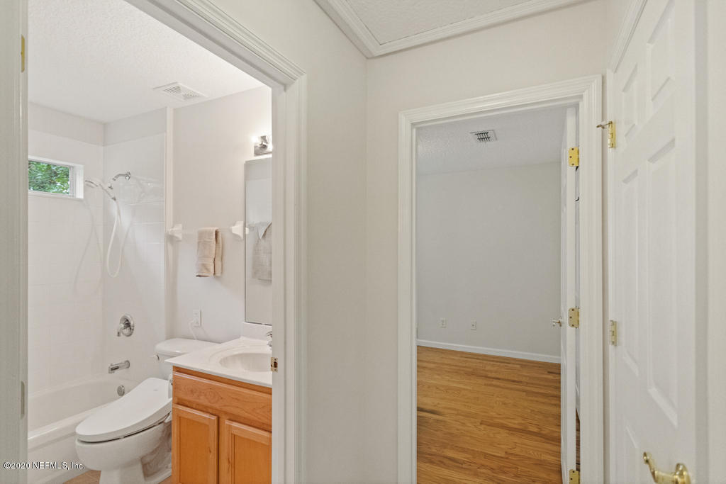 2576 Benjamin Road Jacksonville, FL 32223 - Photo 33 of 53 a bathroom with a granite countertop sink a toilet and shower