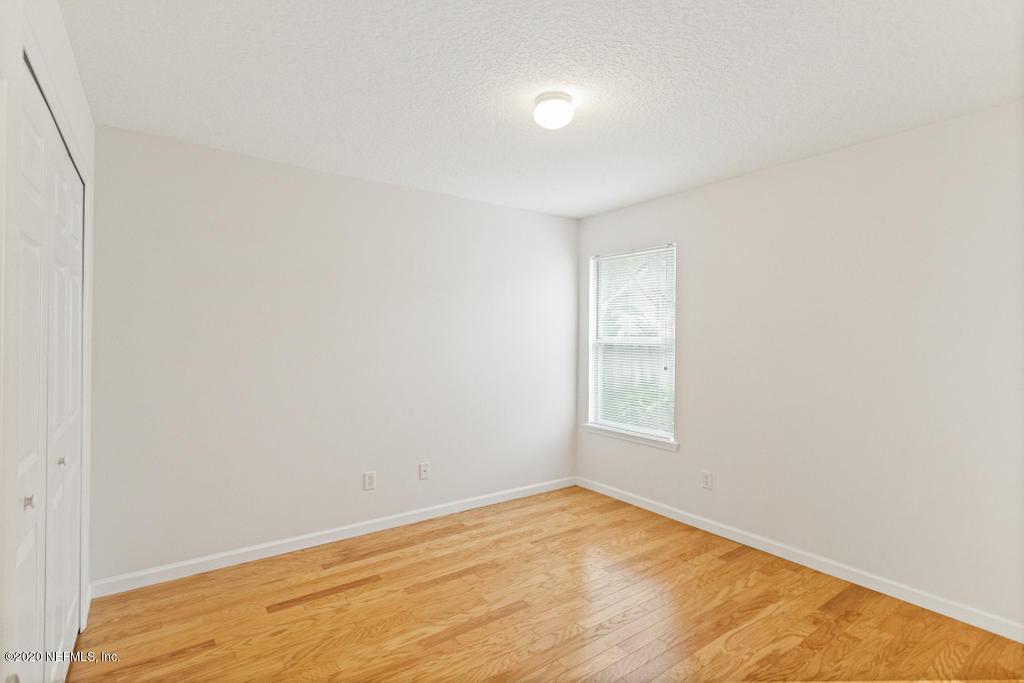 2576 Benjamin Road Jacksonville, FL 32223 - Photo 35 of 53 an empty room with wooden floor and windows