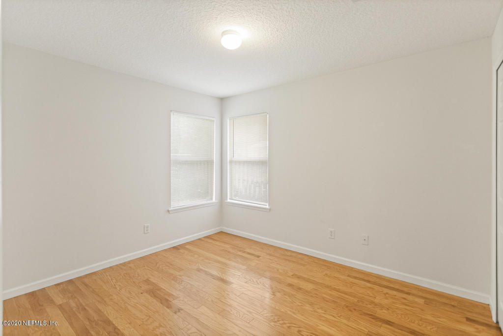 2576 Benjamin Road Jacksonville, FL 32223 - Photo 38 of 53 an empty room with wooden floor and windows