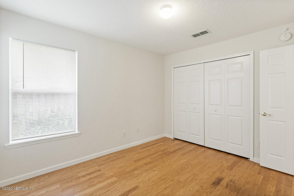 2576 Benjamin Road Jacksonville, FL 32223 - Photo 39 of 53 a view of an empty room with wooden floor and a window