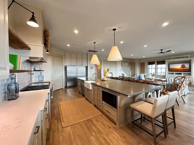 a kitchen with stainless steel appliances granite countertop a sink a stove and a refrigerator