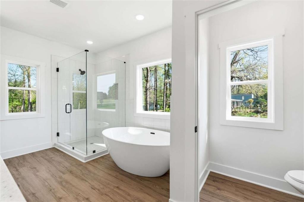 11691 Hazelbrand Road Northeast Covington, GA 30014 - Photo 33 of 53 a bathroom with a white tub shower and window