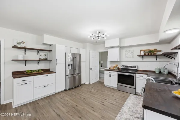 a bedroom with a bed and a night stand