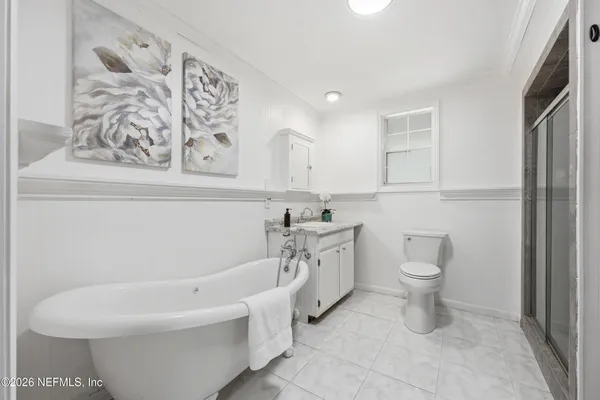 a bathroom with a toilet a sink and a mirror