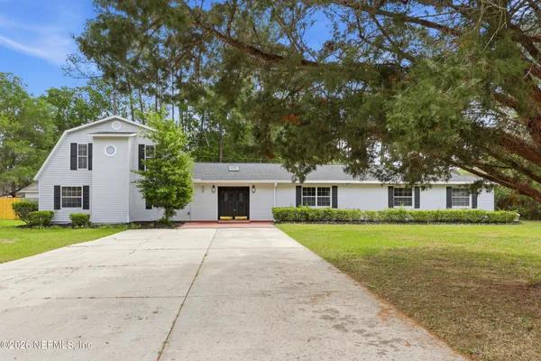 a large kitchen with stainless steel appliances granite countertop a stove refrigerator and a sink