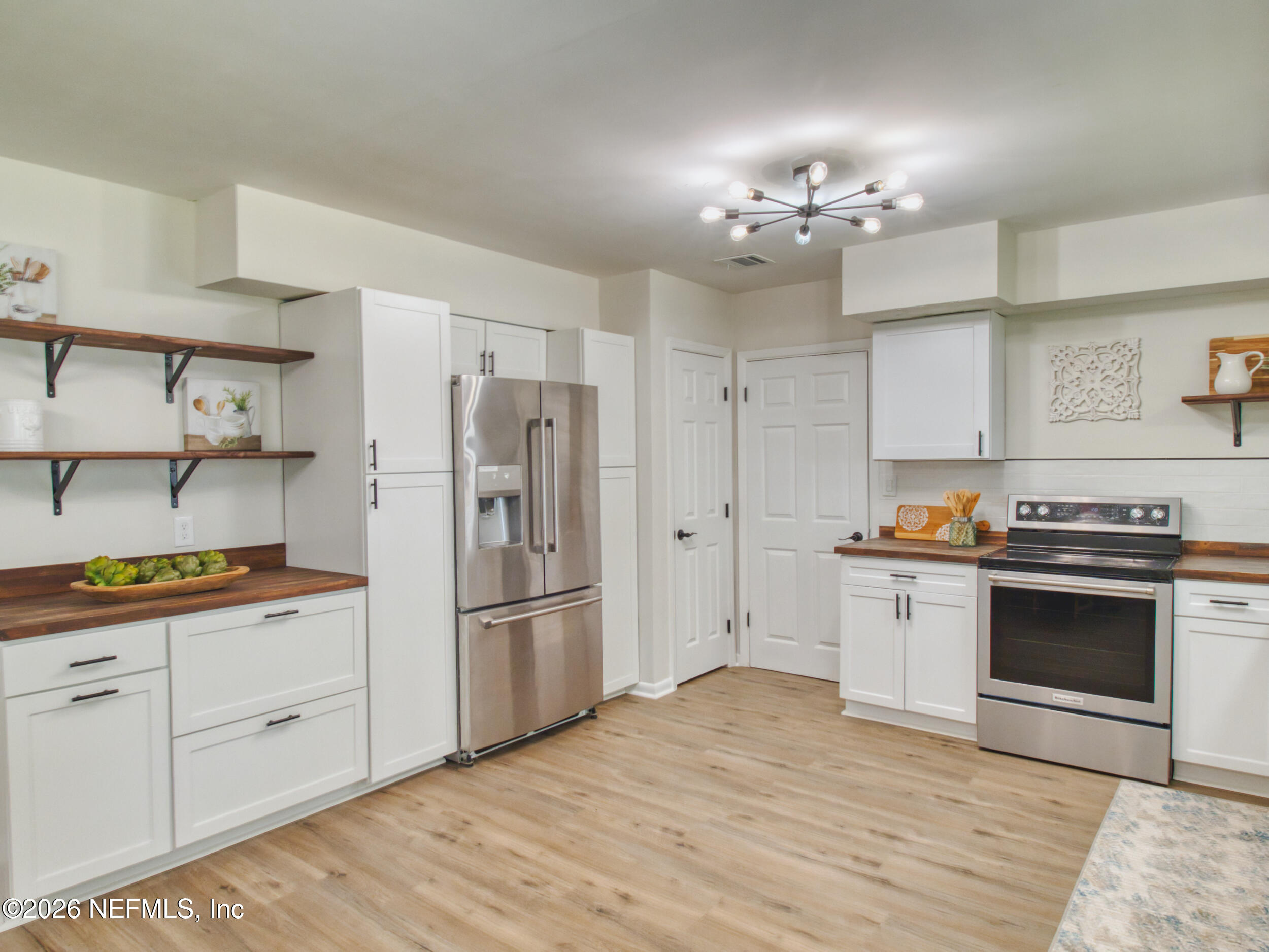 1110 Colley Road Starke, FL 32091 - Photo 60 of 60 a kitchen with granite countertop stainless steel appliances a stove refrigerator and cabinets