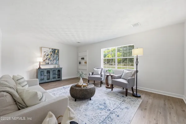a kitchen with kitchen island white cabinets and stainless steel appliances