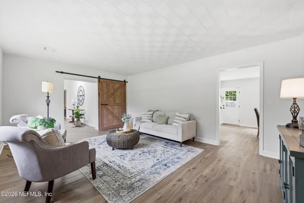 a view of a dining room with furniture window and wooden floor