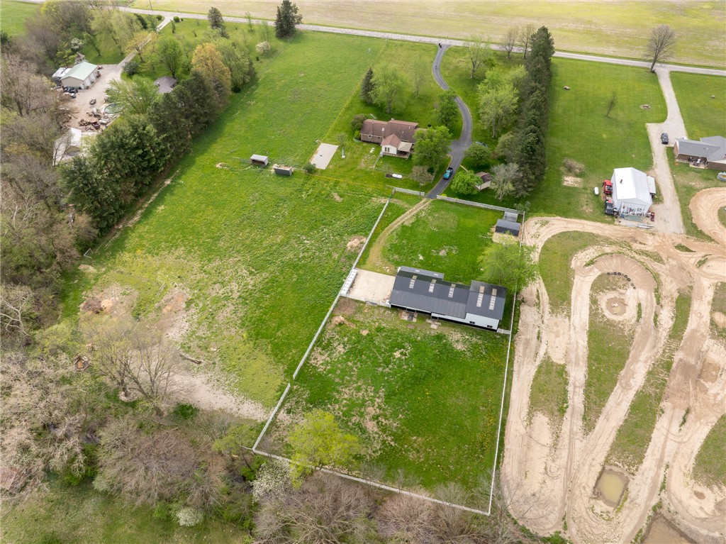 7988 McCool Road Greenville, OH 45331 - Photo 45 of 50 An aerial perspective reveals the expansive grounds of this property, featuring a residential home and surrounding landscape.