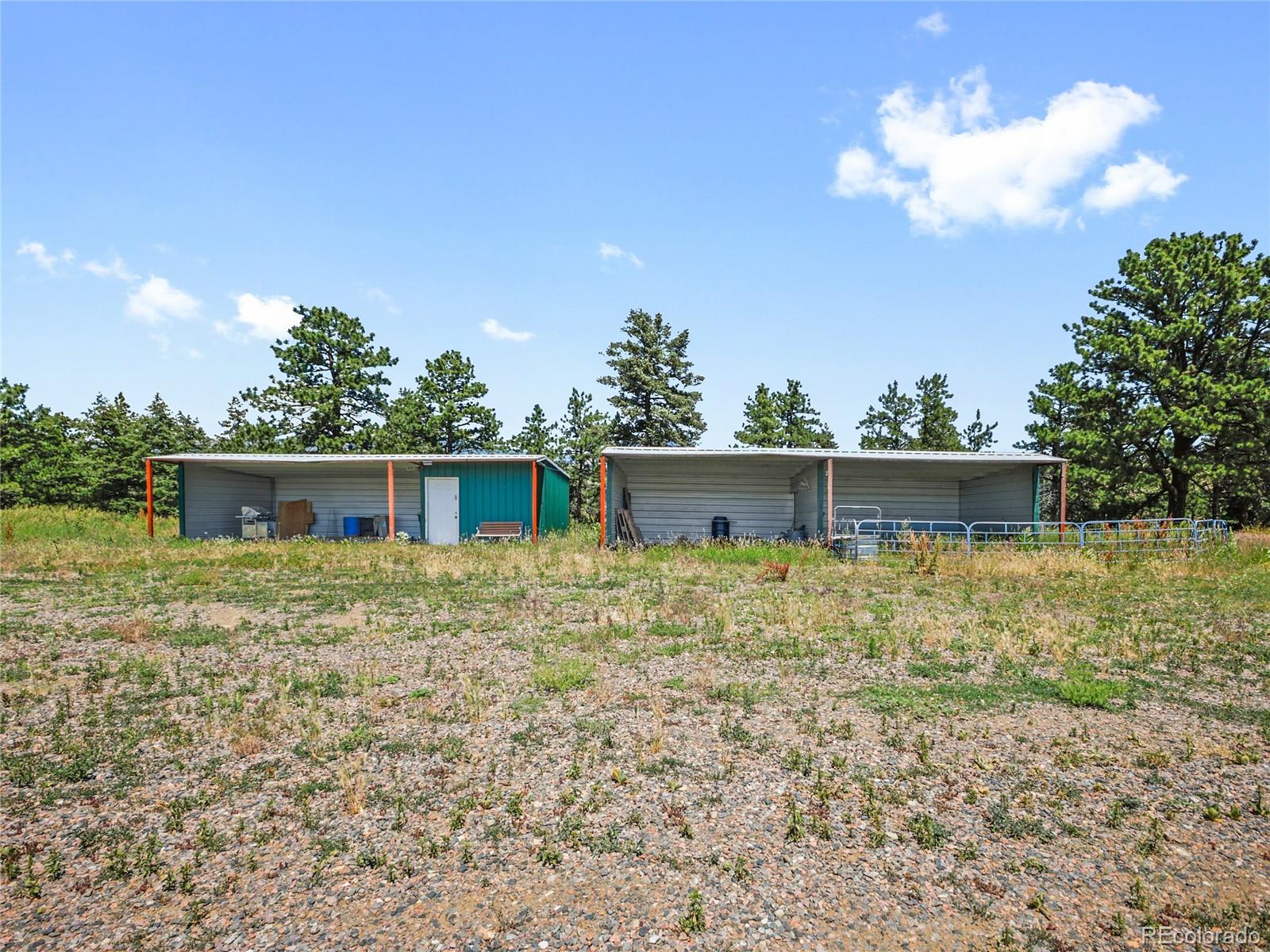 1044 South Grapevine Road Golden, CO 80401 - Photo 39 of 46 a house is sitting in middle of the green field