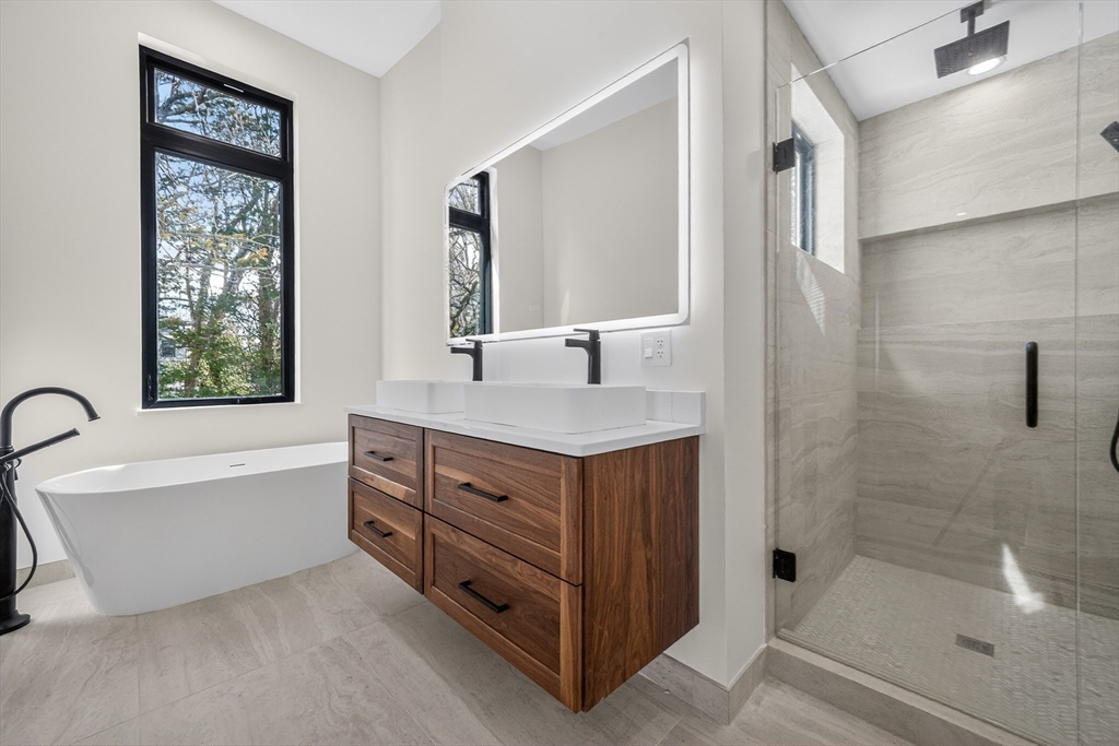 15 Bird Hill Road Lexington, MA 02421 - Photo 21 of 34 a bathroom with a tub sink and mirror