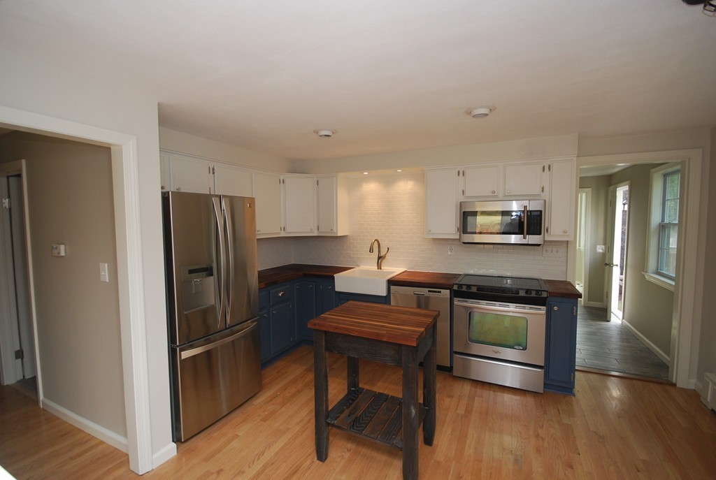 137 Maxwell Road Monson, MA 01057 - Photo 4 of 21 a kitchen with stainless steel appliances a refrigerator stove and microwave
