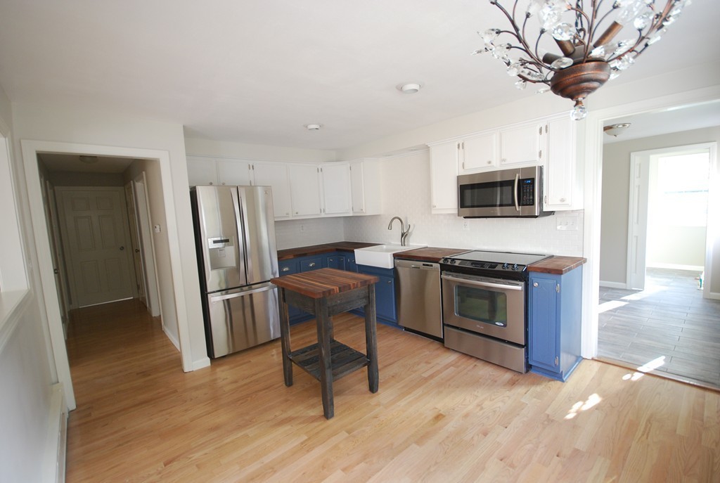 137 Maxwell Road Monson, MA 01057 - Photo 5 of 21 a living room with stainless steel appliances furniture a fireplace and a flat screen tv