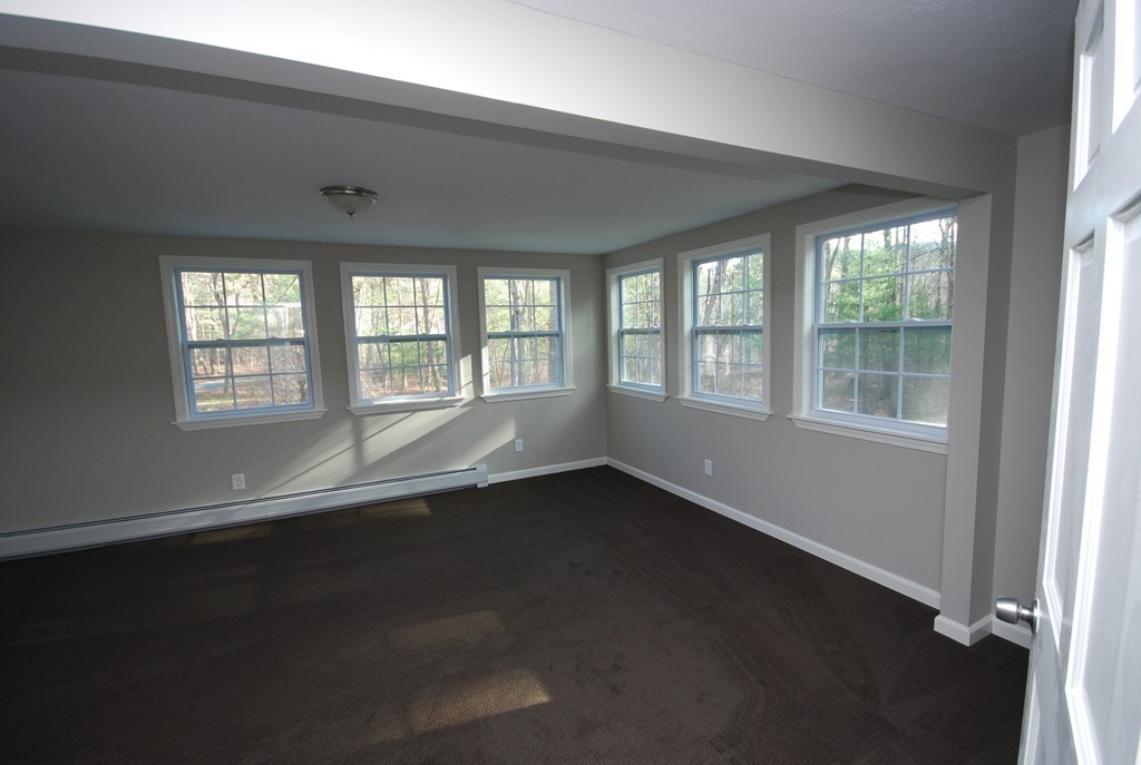 137 Maxwell Road Monson, MA 01057 - Photo 8 of 21 an empty room with wooden floor and windows