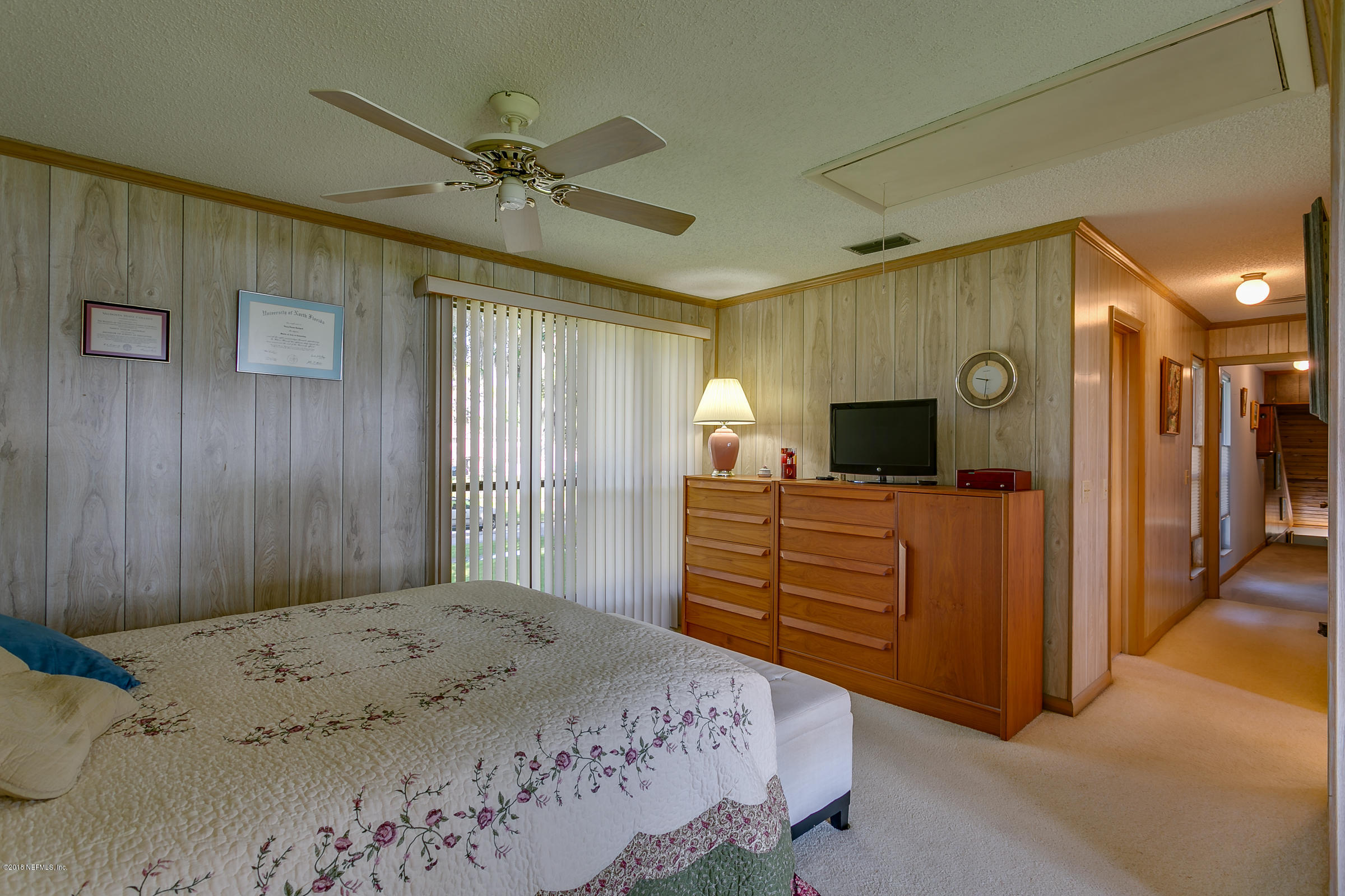 5562 Steamboat Road St. Augustine, FL 32092 - Photo 17 of 49 a bedroom with a bed and a chandelier