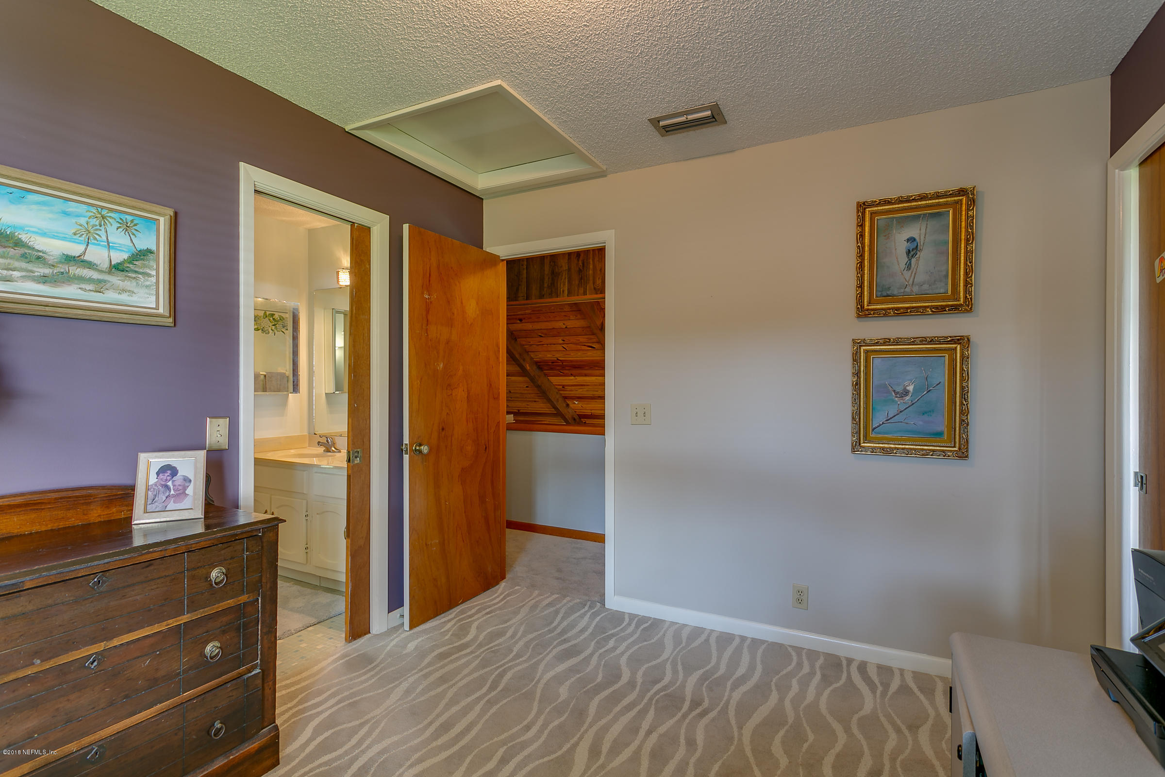 5562 Steamboat Road St. Augustine, FL 32092 - Photo 24 of 49 a bedroom with a bed and a dresser
