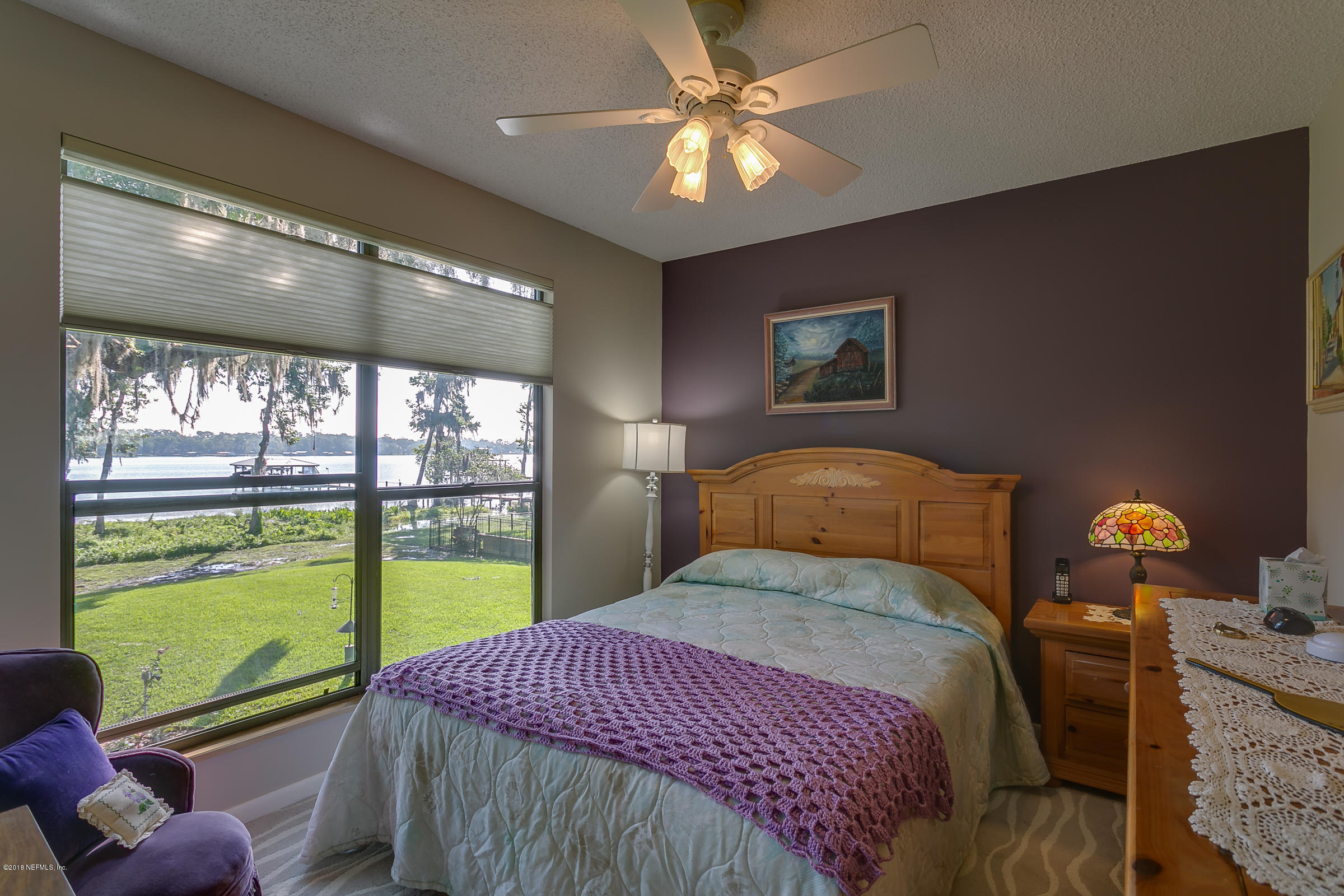 5562 Steamboat Road St. Augustine, FL 32092 - Photo 26 of 49 a bedroom with a large bed and a window