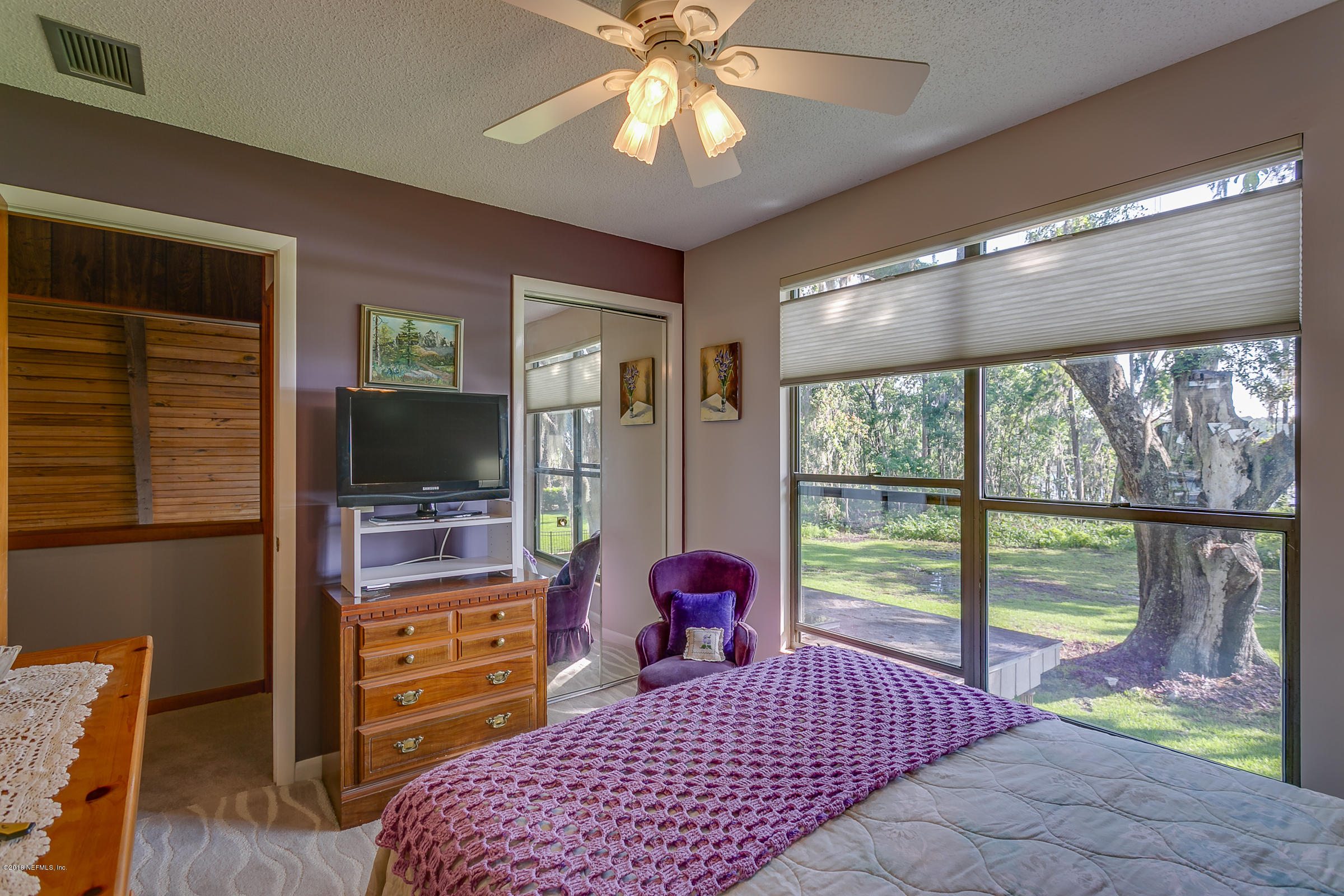 5562 Steamboat Road St. Augustine, FL 32092 - Photo 27 of 49 a bedroom with a bed and a flat screen tv