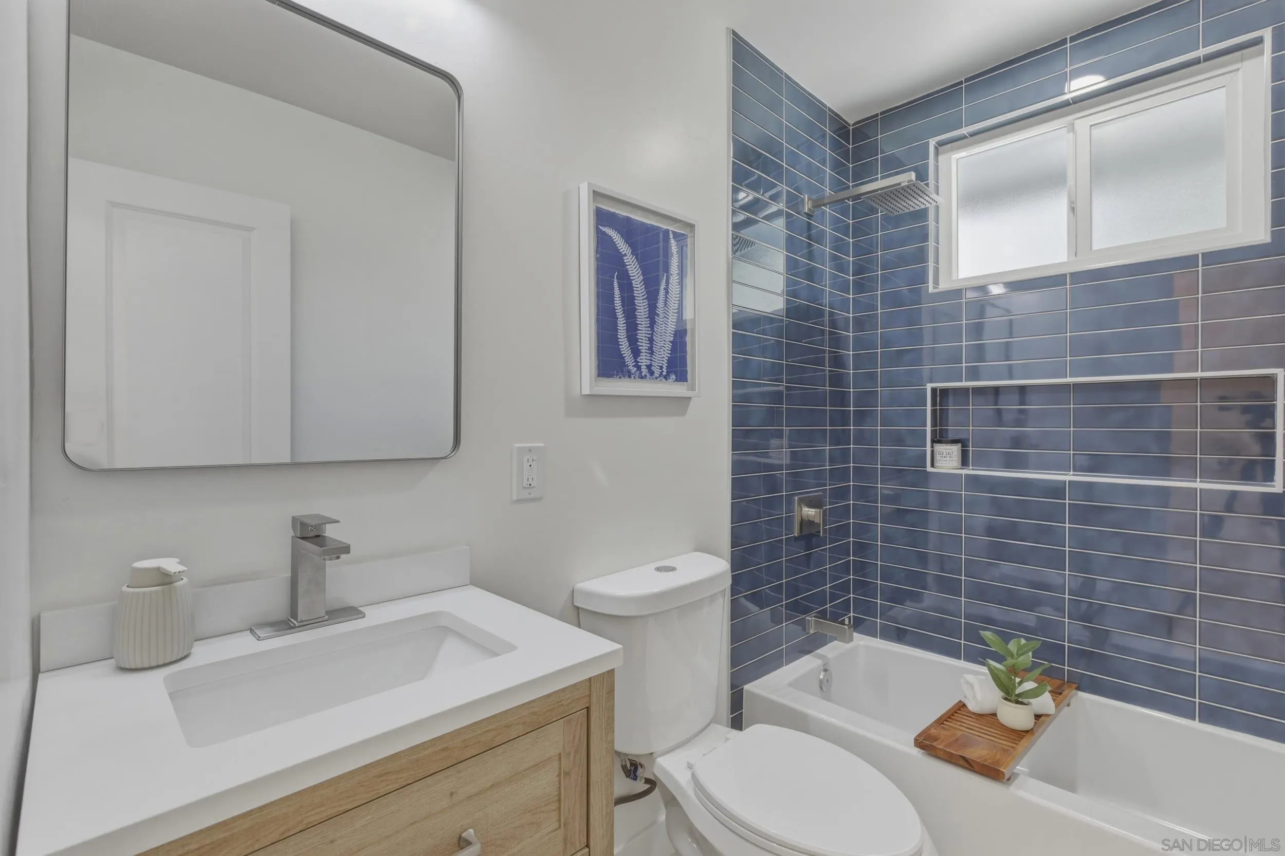 1862 Washington Street Lemon Grove, CA 91945 - Photo 16 of 32 a bathroom with a sink a toilet and mirror
