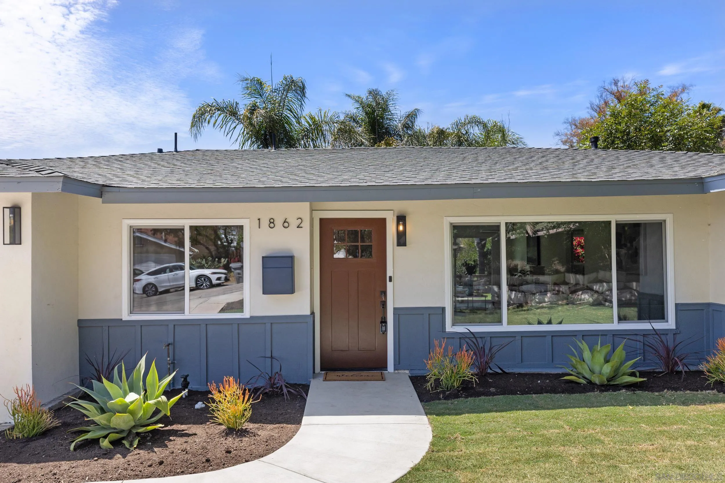 1862 Washington Street Lemon Grove, CA 91945 - Photo 3 of 32 a front view of a house with a garden