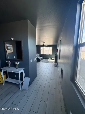 a view of a livingroom with furniture and a window