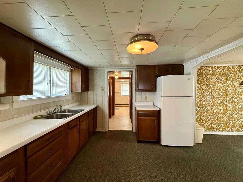 222 Bagdad Road Leechburg, PA 15656 - Photo 13 of 23 a kitchen with a sink a refrigerator and a stove