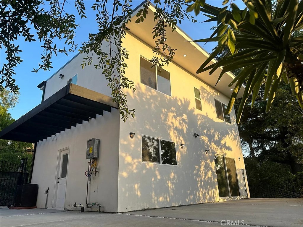 22823 Crespi Street Woodland Hills, CA 91364 - Photo 2 of 15 a front view of a house with a tree