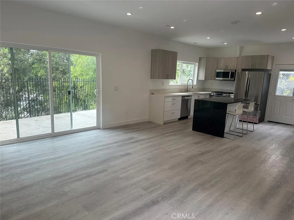 22823 Crespi Street Woodland Hills, CA 91364 - Photo 4 of 15 a kitchen with stainless steel appliances granite countertop a refrigerator a sink a stove top oven a counter space and cabinets