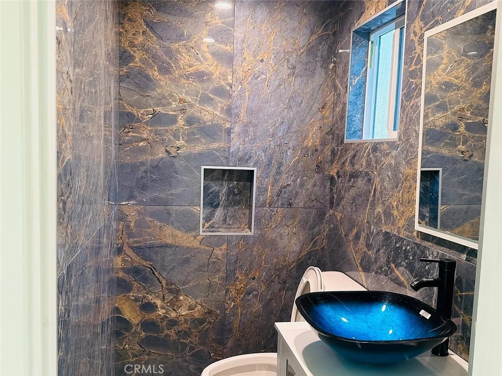 22823 Crespi Street Woodland Hills, CA 91364 - Photo 5 of 15 a bathroom with a toilet and a sink