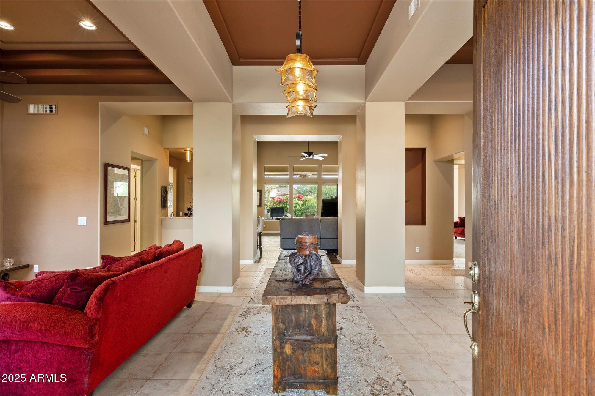 6867 East Crimson Sky Trail Scottsdale, AZ 85266 - Photo 11 of 97 a living room with furniture and a chandelier