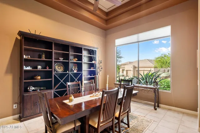 a kitchen with a sink a stove a refrigerator and black cabinets with wooden floor