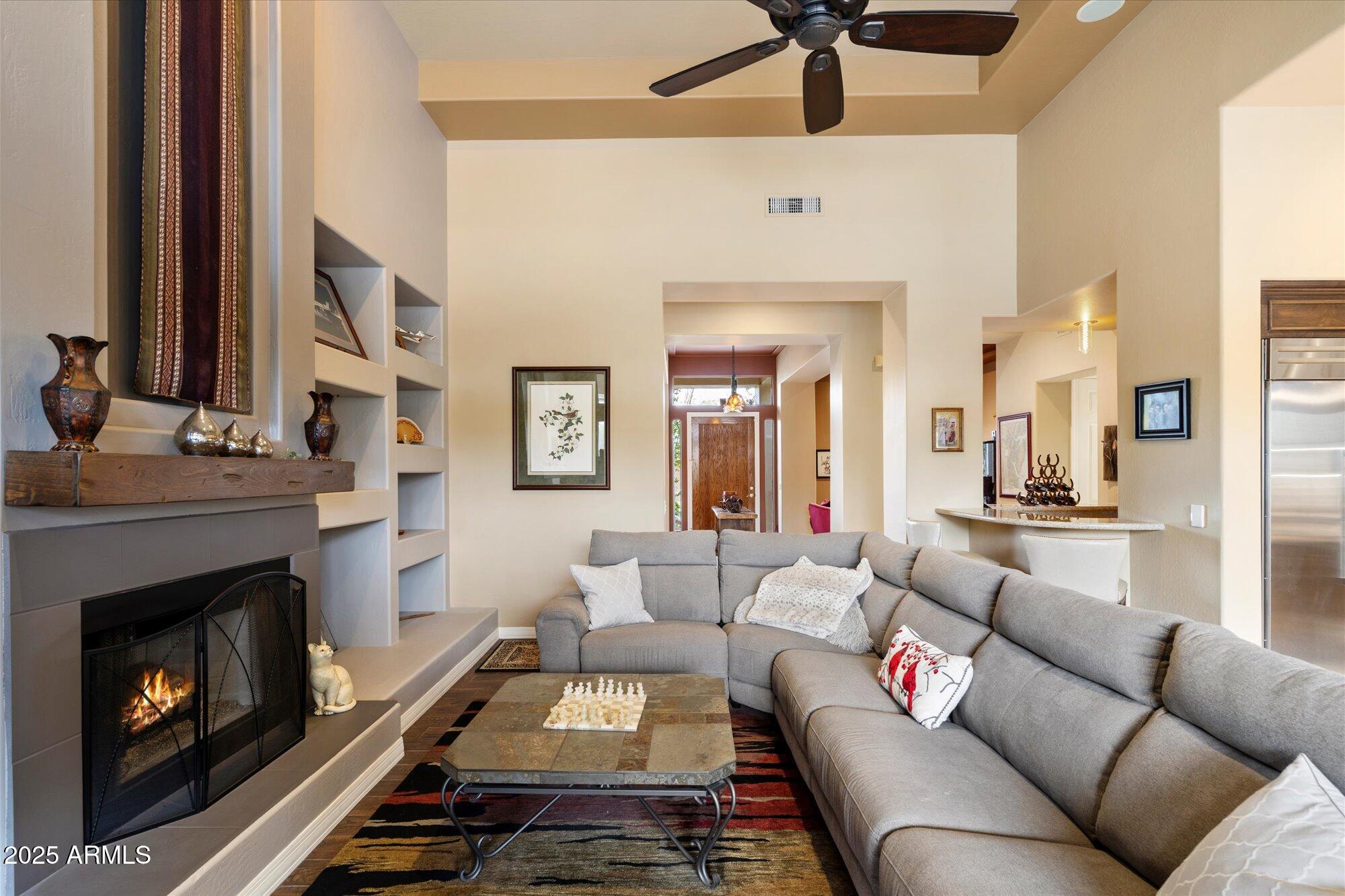 6867 East Crimson Sky Trail Scottsdale, AZ 85266 - Photo 17 of 97 a living room with furniture and a fireplace