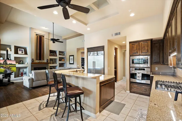a bathroom with a granite countertop sink mirror and shower